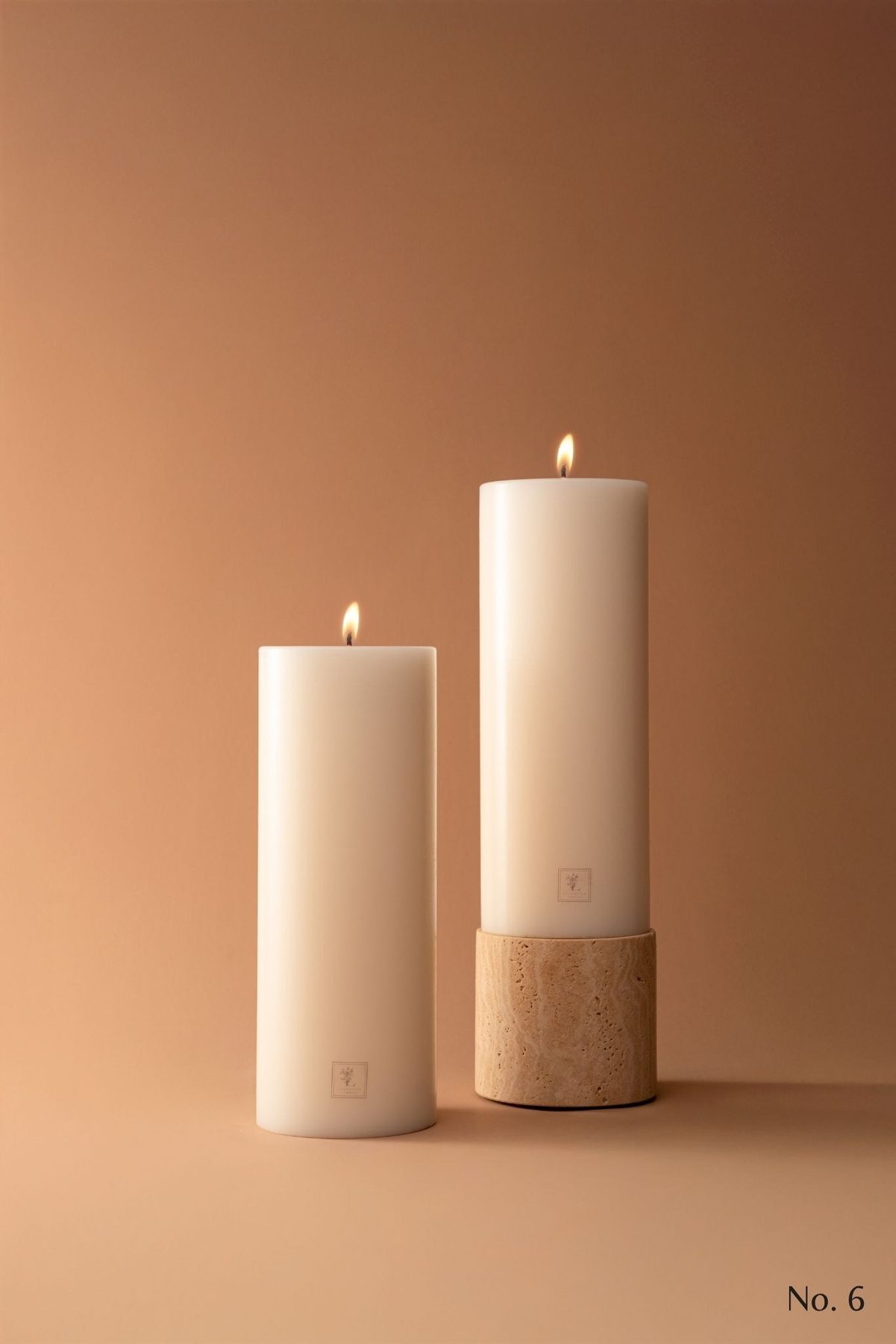 Two candles on travertine base