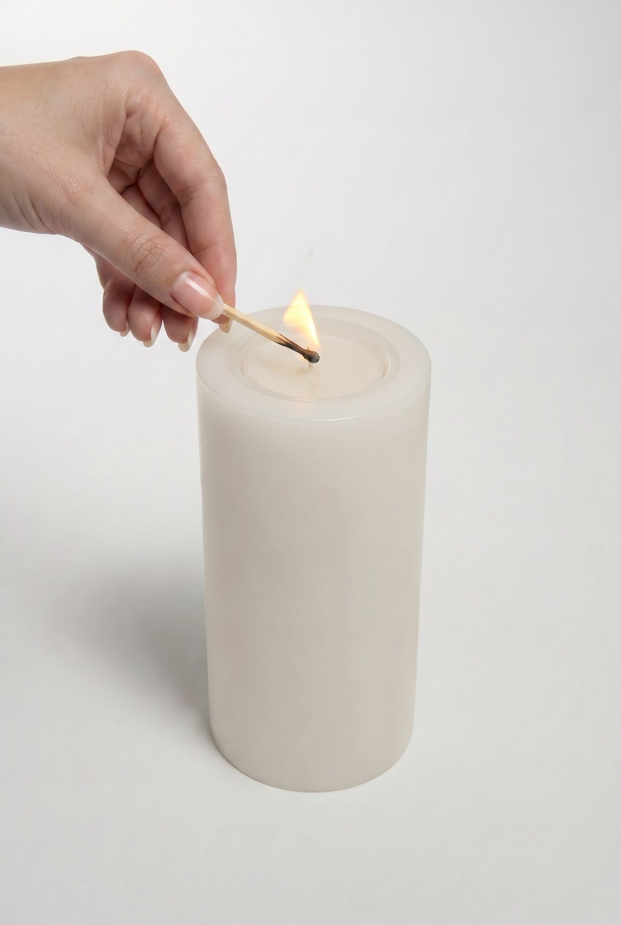 Lighting the candle with a match